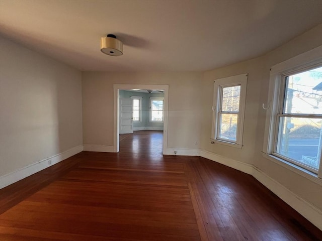 empty room featuring ceiling fan and dark wood-type flooring