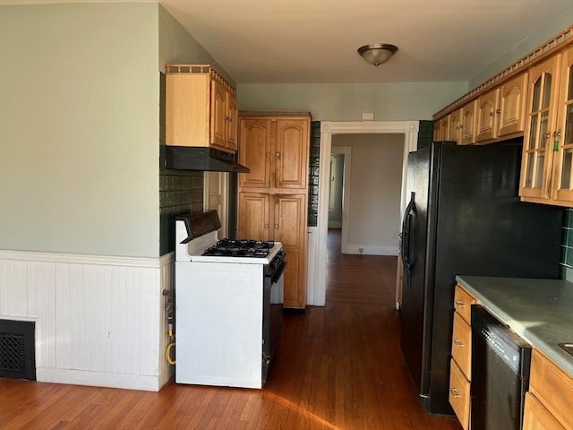 kitchen featuring black appliances and dark hardwood / wood-style floors