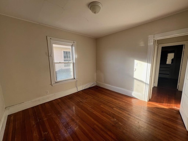 spare room with dark hardwood / wood-style flooring