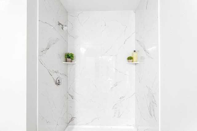 full bathroom with a marble finish shower