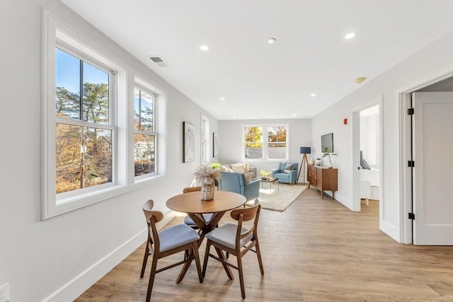 dining space with baseboards, recessed lighting, light wood finished floors, and visible vents