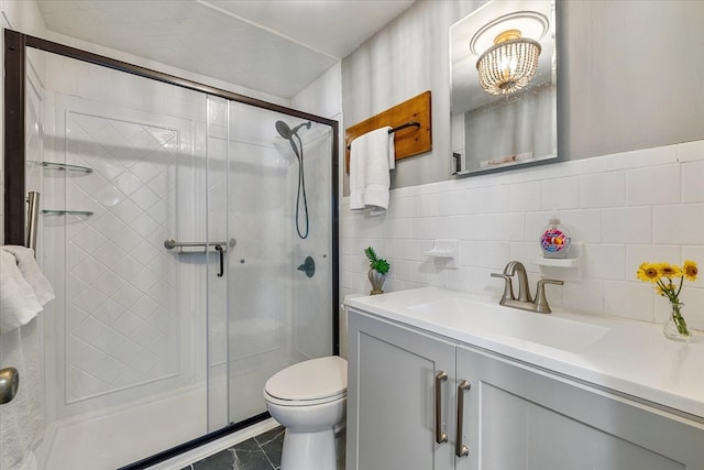 bathroom with walk in shower, tile walls, vanity, and toilet