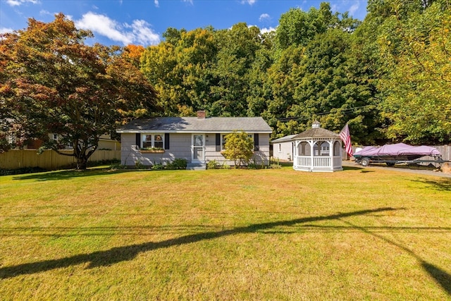 view of front of property featuring a front lawn and a gazebo