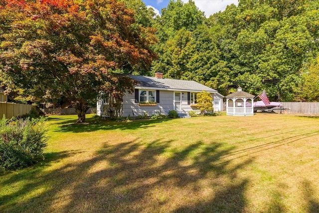 view of front facade featuring a gazebo and a front lawn