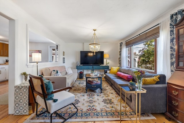 living room featuring light hardwood / wood-style flooring and a chandelier