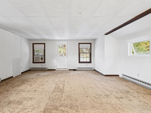 spare room with a baseboard radiator, cooling unit, and carpet flooring