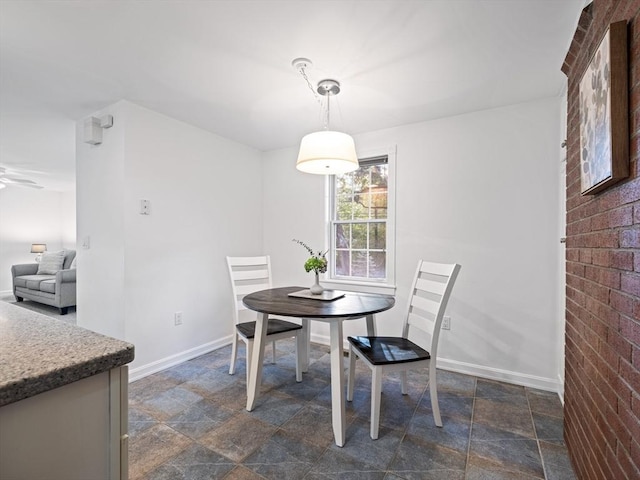 dining room with brick wall