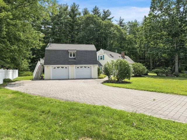 view of front of home featuring a garage and a front yard