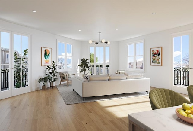 living room with a notable chandelier and light wood-type flooring