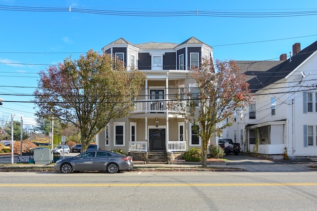 view of front of house with a porch and a balcony