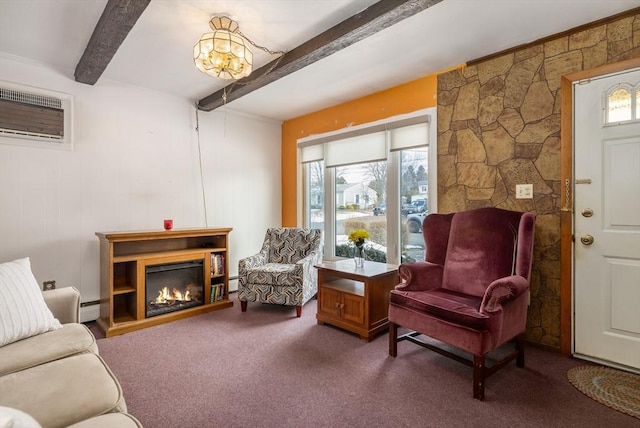 sitting room featuring a wall unit AC, carpet, a fireplace, a baseboard radiator, and beamed ceiling