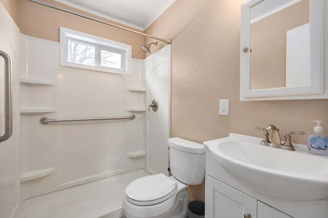 bathroom with vanity, toilet, and a shower