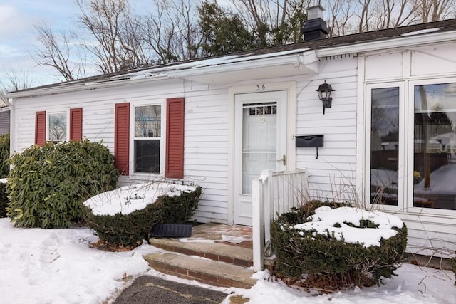 view of snow covered property entrance