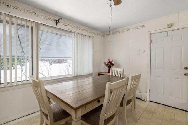 dining space featuring ornamental molding and a baseboard heating unit