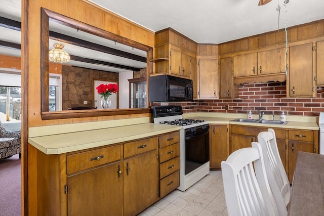 kitchen featuring tasteful backsplash, gas stove, sink, and beam ceiling