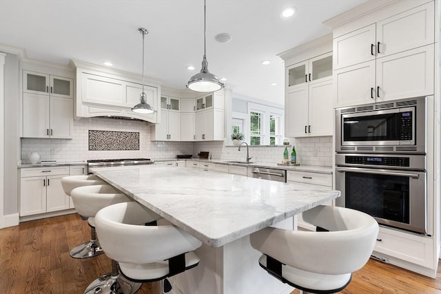 1 Apollo Cir, Lexington, MA 02421 - kitchen featuring stainless steel appliances, a breakfast bar area, a center island, white cabinetry, and recessed lighting
