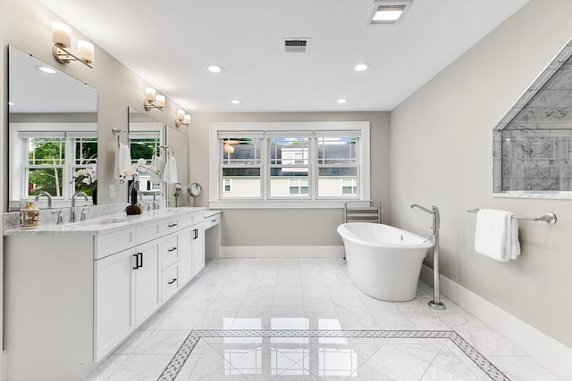 1 Apollo Cir, Lexington, MA 02421 - bathroom featuring double vanity, a freestanding bath, recessed lighting, inlaid floor details, and marble finish floors
