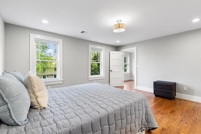 1 Apollo Cir, Lexington, MA 02421 - bedroom with multiple windows, wood finished floors, and recessed lighting