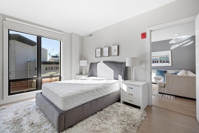 bedroom with hardwood / wood-style flooring