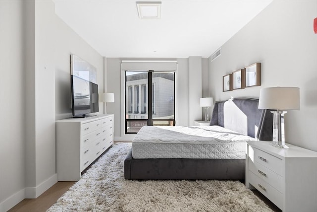 bedroom featuring access to outside and light hardwood / wood-style floors