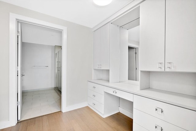 interior space featuring vanity and wood-type flooring