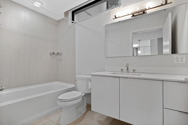 full bathroom featuring tile patterned floors, toilet, tiled shower / bath combo, and vanity