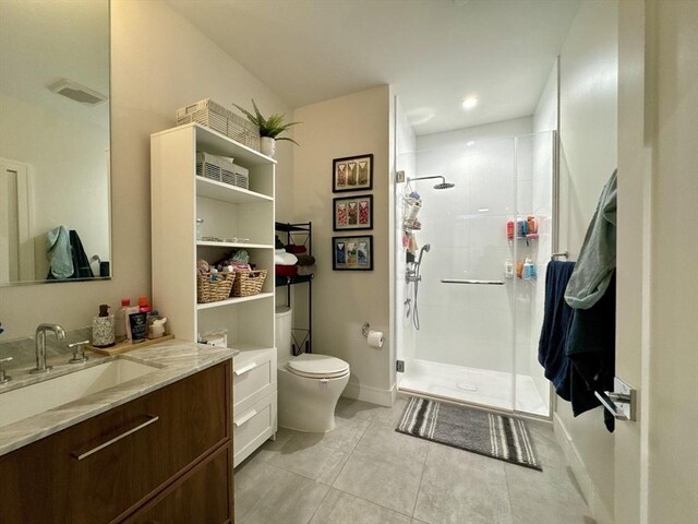 99 Sumner St Unit 305, Boston, MA 02128 - bathroom with a stall shower, toilet, vanity, and tile patterned floors
