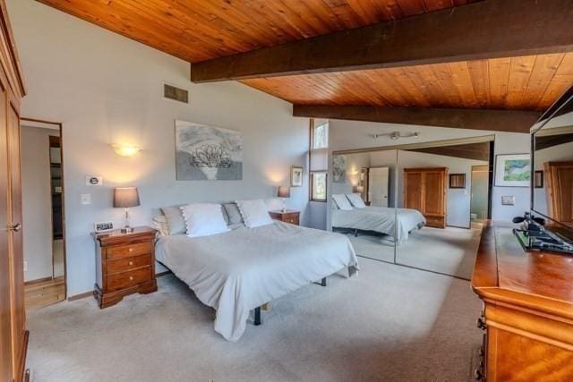 bedroom with visible vents, light colored carpet, and wooden ceiling