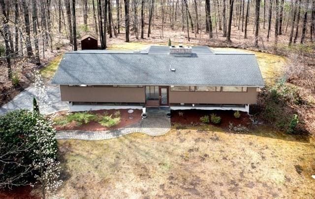 drone / aerial view with a wooded view