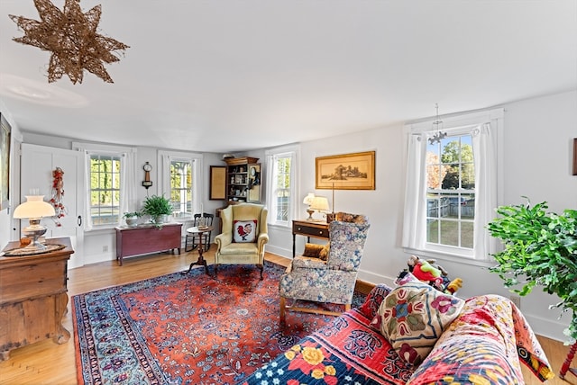 living room with wood-type flooring and a chandelier