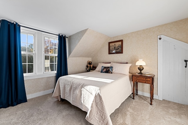 bedroom with vaulted ceiling and carpet floors