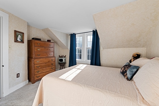 bedroom with carpet flooring and vaulted ceiling