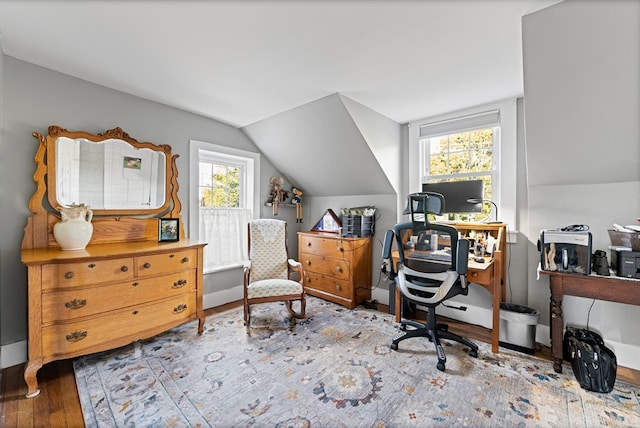 office space with lofted ceiling and light hardwood / wood-style floors