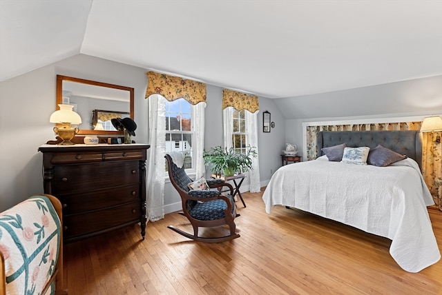 bedroom featuring vaulted ceiling and light wood-type flooring