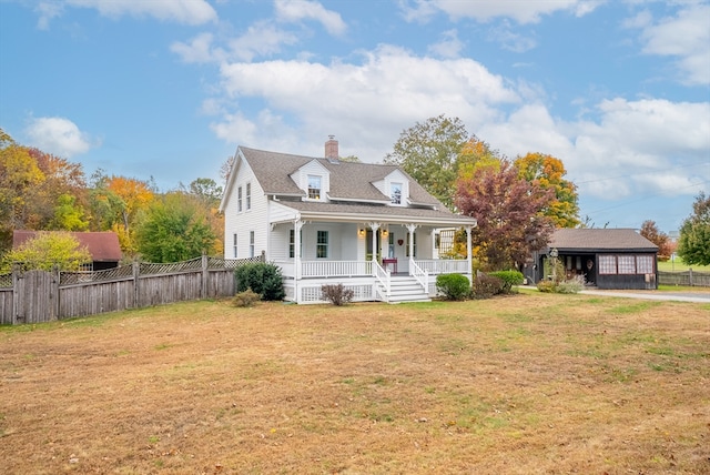 new england style home with covered porch and a front lawn