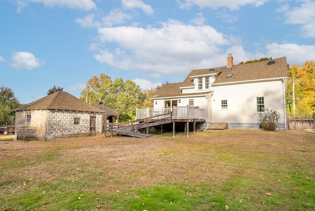 back of house featuring a yard and a deck