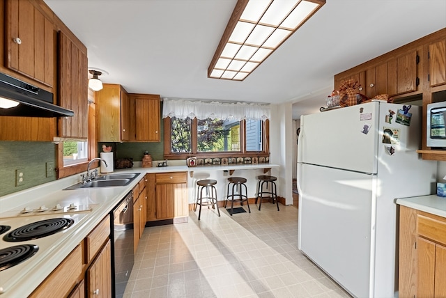 kitchen featuring sink, exhaust hood, backsplash, and white appliances