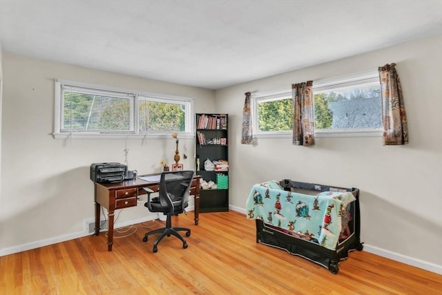 home office with hardwood / wood-style floors