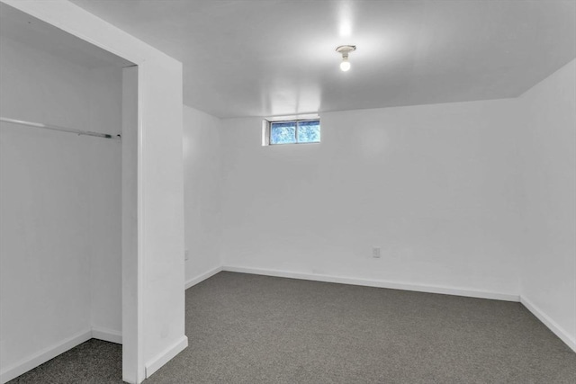 basement featuring dark colored carpet