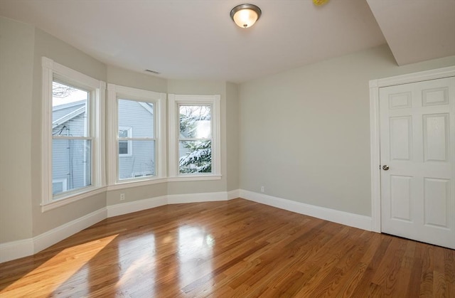 unfurnished room with light wood-type flooring