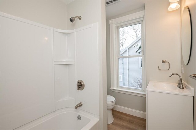 full bathroom with vanity, hardwood / wood-style flooring, plenty of natural light, and shower / washtub combination