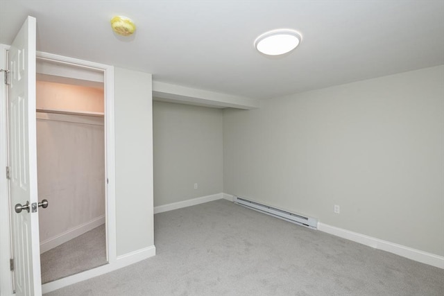 unfurnished bedroom featuring a baseboard heating unit, light colored carpet, and a closet