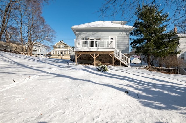 snow covered property featuring a wooden deck