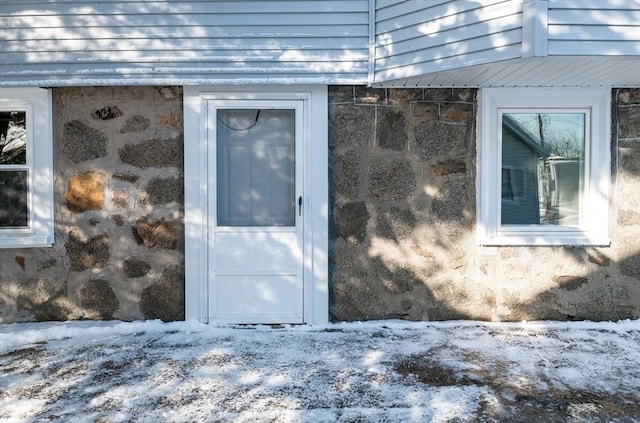 view of snow covered property entrance