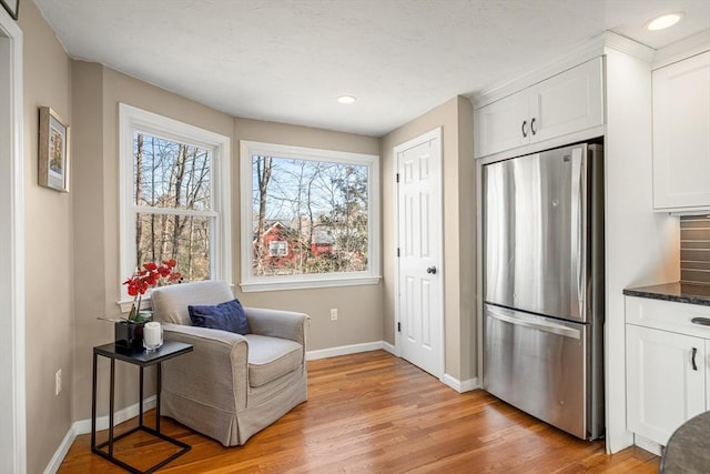 sitting room with recessed lighting, light wood-type flooring, and baseboards