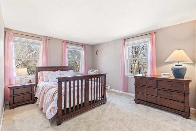 bedroom with carpet flooring, multiple windows, and baseboards