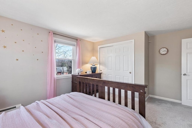 bedroom with a closet, carpet, baseboards, and baseboard heating