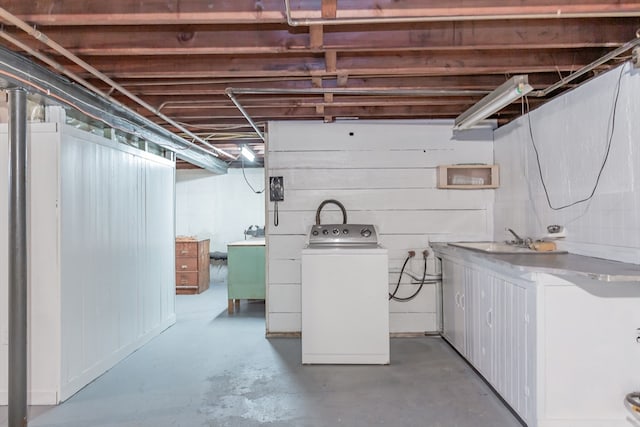 basement featuring washer / dryer and sink