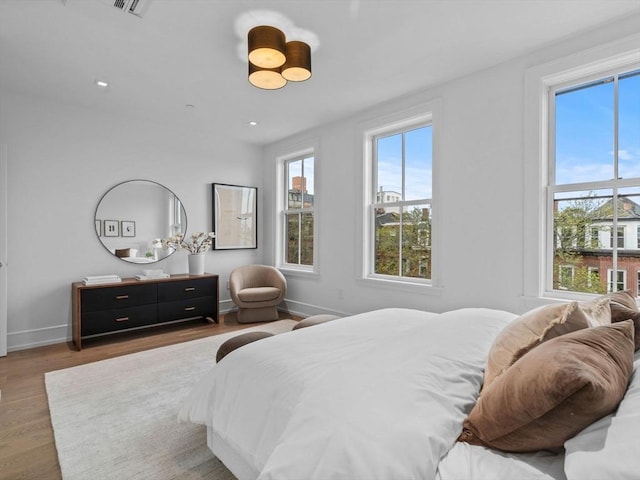 bedroom with wood finished floors and baseboards