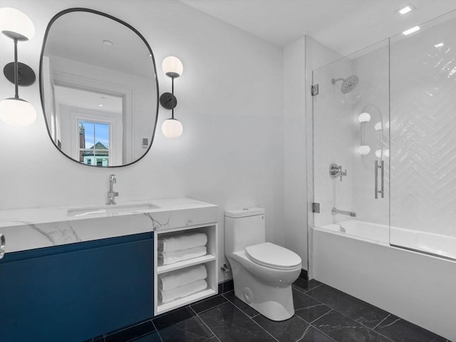 full bathroom with toilet, marble finish flooring, combined bath / shower with glass door, and vanity
